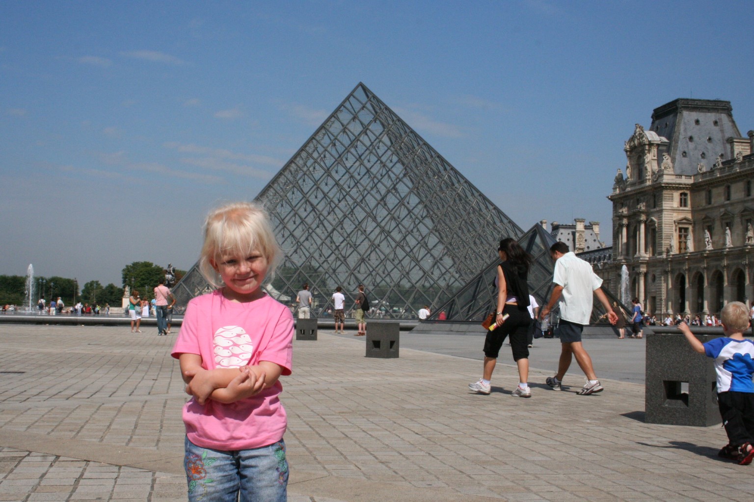 cute kid in front of Louvre pyramid